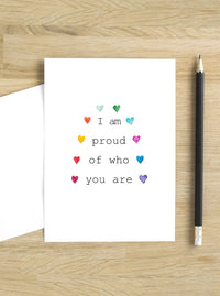 I am proud of you rainbow LGBTQ+ Pride card. Delicate multi color hearts around the Title in a rainbow fashion