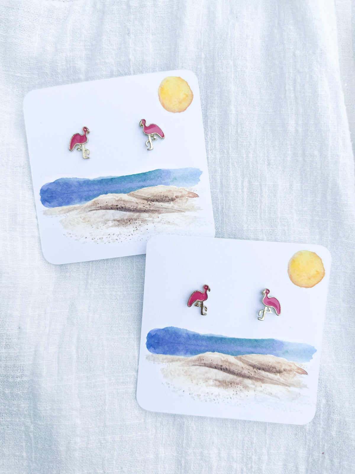 pink flamingo stud earrings on beach card