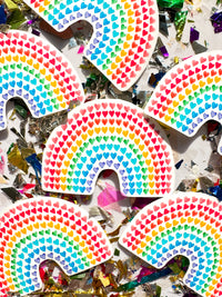 Colorful display of mini hearts forming the shape and color of the rainbow