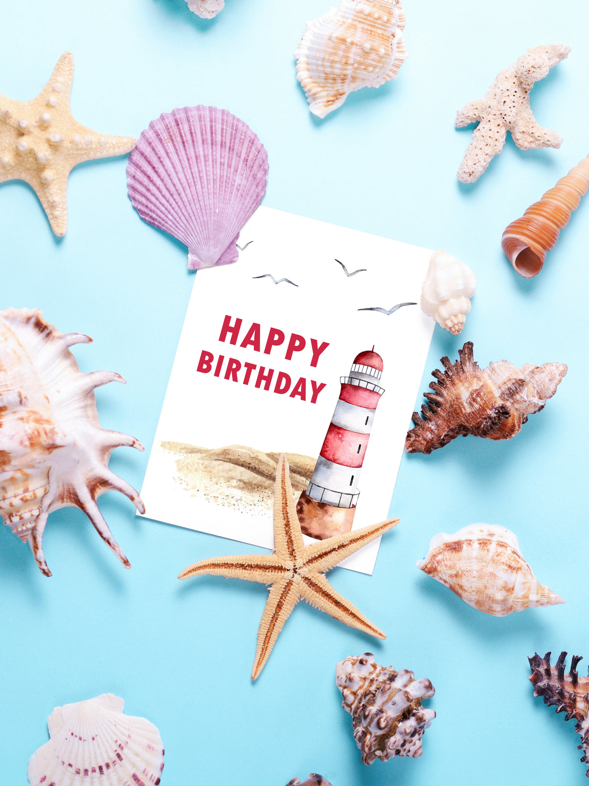 "A picturesque sandy beach with a red and white lighthouse set against a serene coastal backdrop, complemented by a heartfelt Happy Birthday in Red Lettering card design, evoking gratitude and a sense of calm seaside "