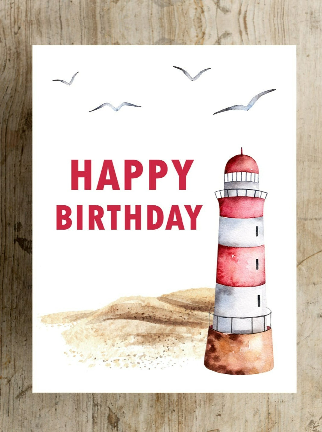 "A picturesque sandy beach with a red and white lighthouse set against a serene coastal backdrop, complemented by a heartfelt Happy Birthday in Red Lettering card design, evoking gratitude and a sense of calm seaside "