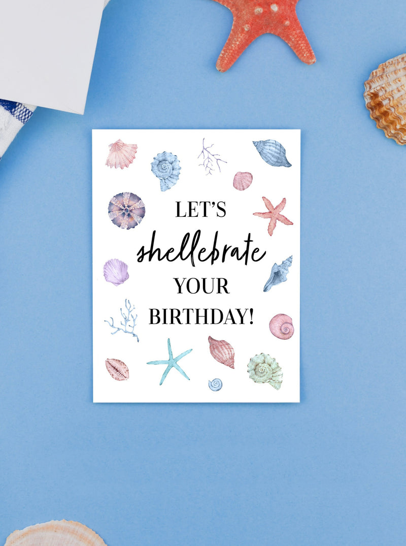 "An artistic depiction of delicate seashells scattered on a sandy beach, accompanied by a vibrant and cheerful birthday card design featuring beach-themed elements, perfect for celebrating a special day by the sea." Light blue pale red, cream colors with Black lettering